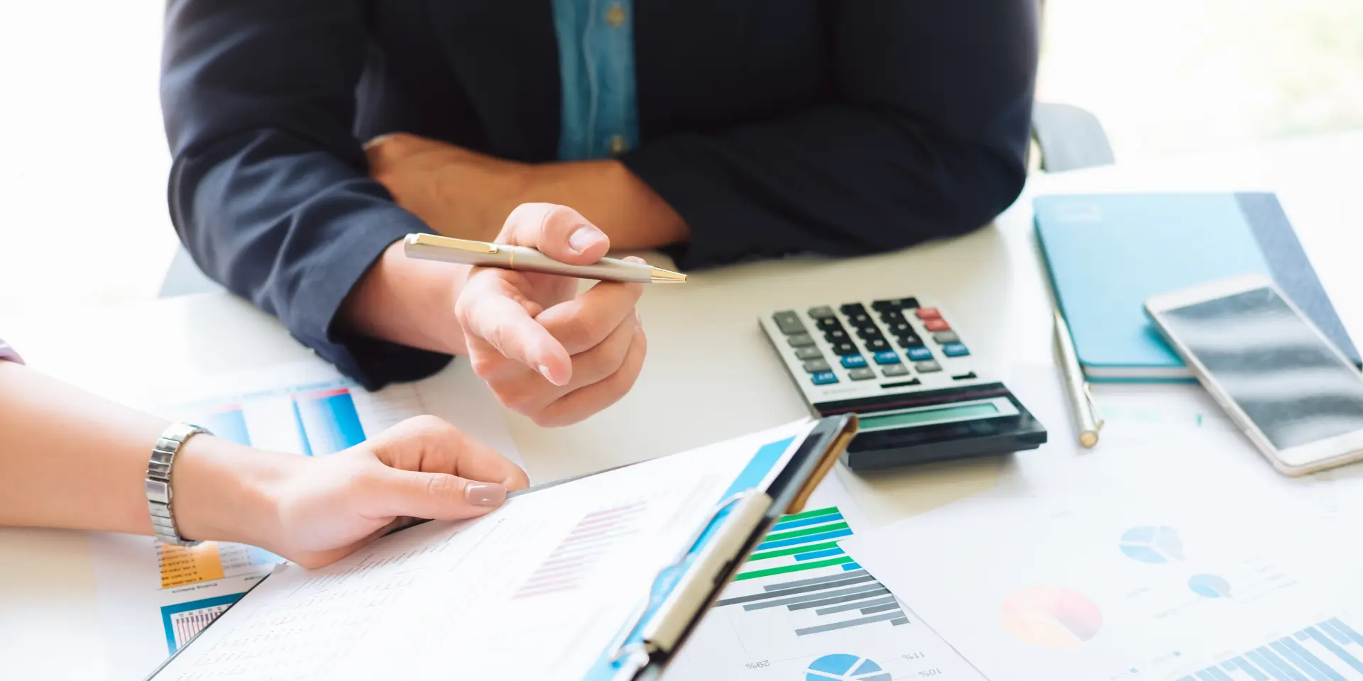 Real estate accounting team reviewing portfolio performance reports